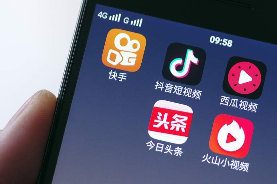 Mobile video apps including Kuaishou, Douyin, Xigua and Huoshan are displayed on the screen of a 4G smartphone. [Photo provided to China Daily]
